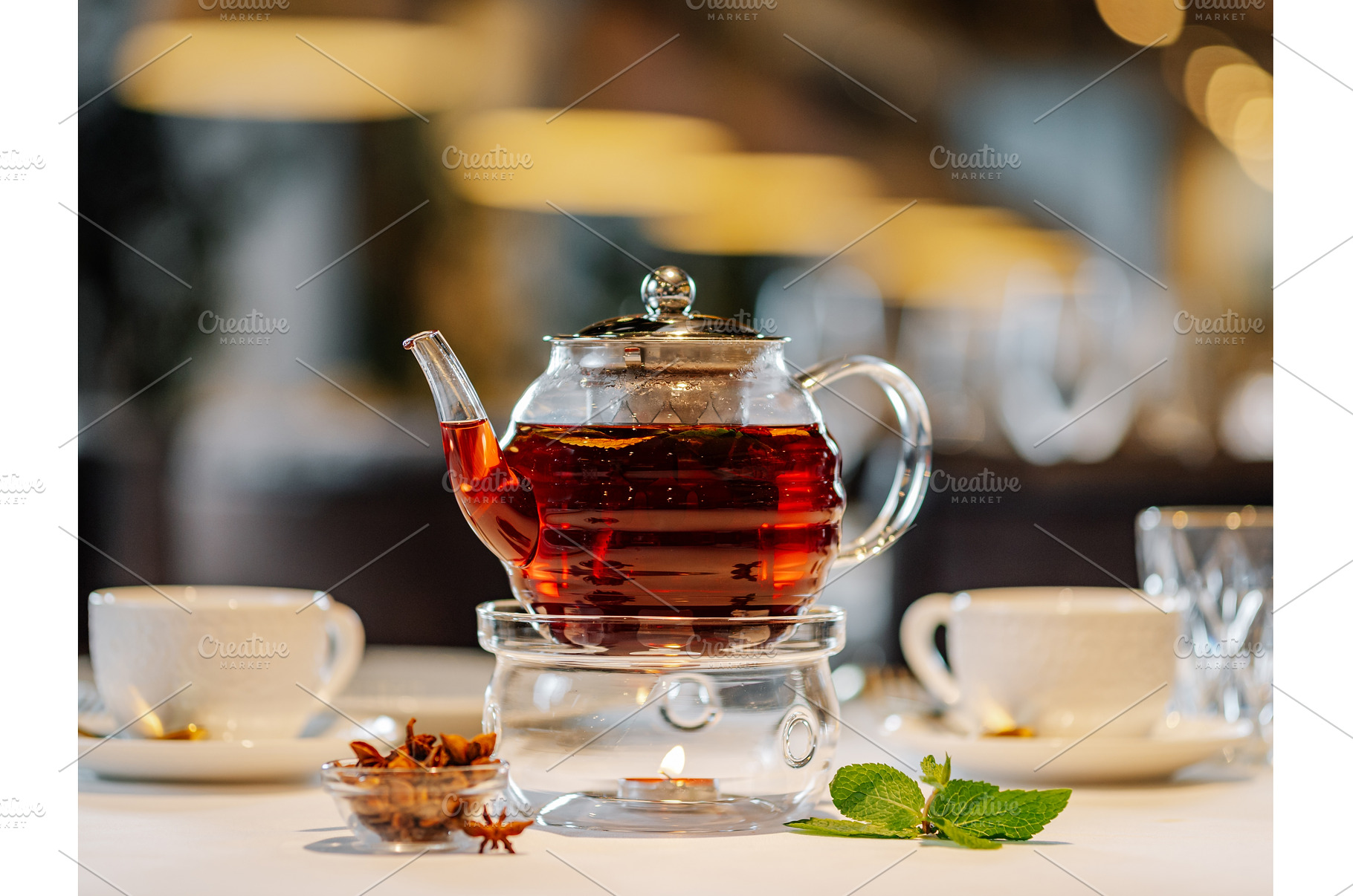 Glass teapot with warmer on table in, a Food & Drink Photo by Fascinadora