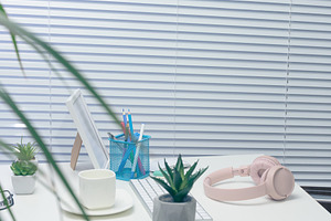 Desk with white keyboard, pink headphones, potted cacti, photo f, a Technology Photo by ndanko