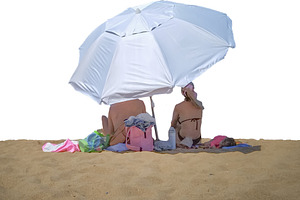 Couple relaxing under an umbrella at sand isolated photo, a Person Photo by DanFLCreativo