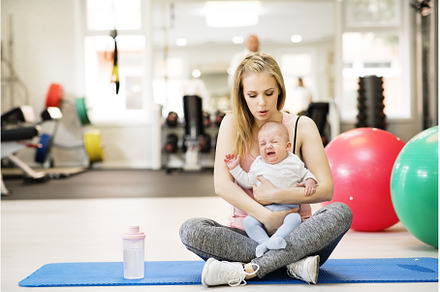 Portrait of new mom holding crying, a Sports & Recreation Photo by HalfPoint