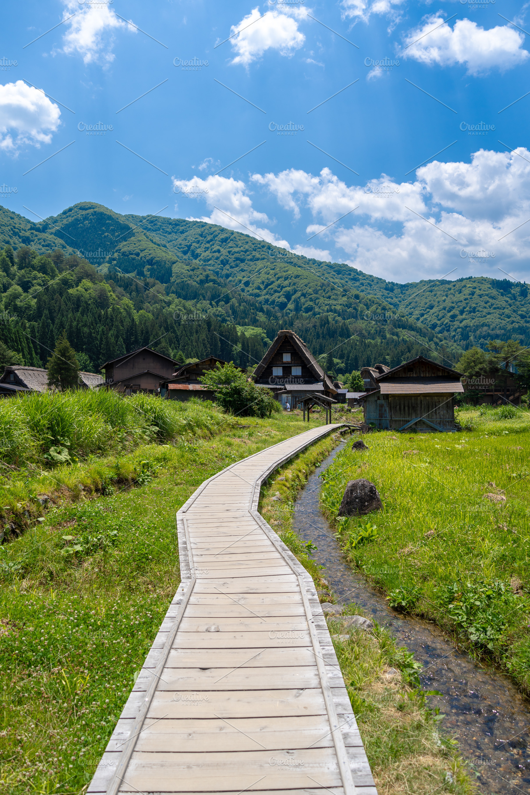 Wooden path crossing traditional village of Shirakawa-go in Japa, a Nature Photo by GoodGoods