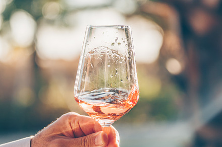 Swirling glass of rose wine at wine, a Holiday Photo by Kate Molchanova