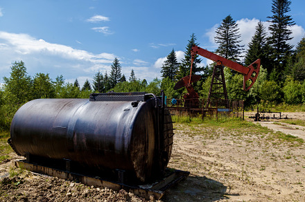 Oil rig pumping oil from underground, an Industrial Photo by Photostock