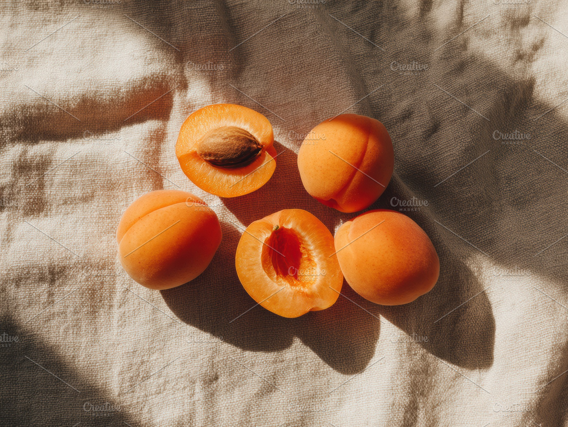 Fresh apricot halves on tablecloth, a Photo by Virgo Studio