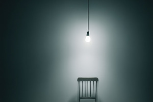 Empty Chair Under Bare Bulb Light, a Wallpaper Photo by Virgo Studio