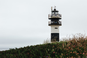 Modern black and white lighthouse on, an Architecture Photo by Perpis