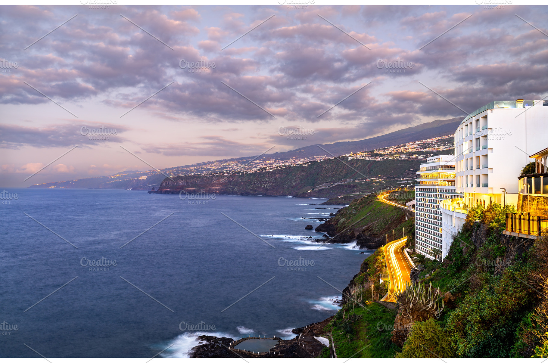 Illuminated resort building on the, an Architecture Photo by Leonid Andronov