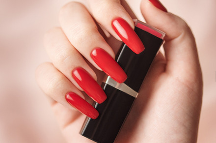 The hand of a young girl with a bright red manicure on her nails, a Beauty & Fashion Photo by Olena Rudo