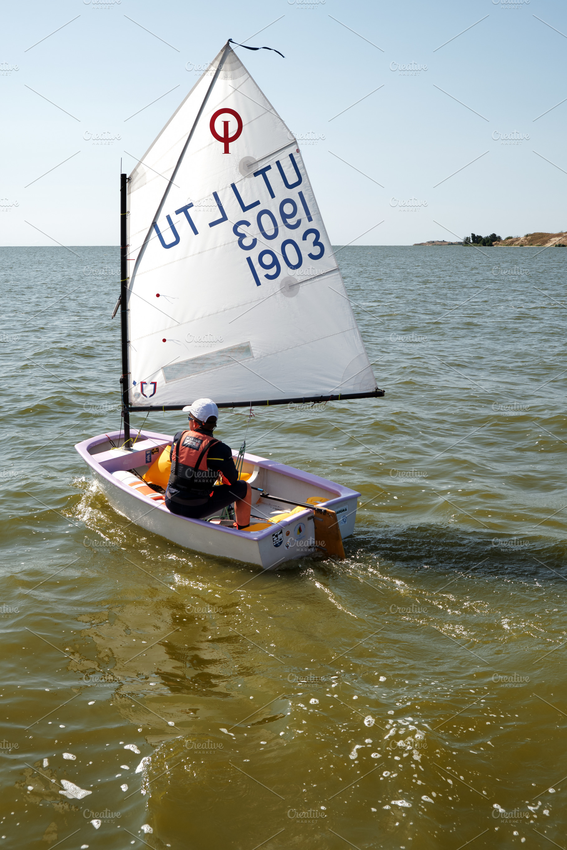 Young child sailing Optimist boat, a Sports & Recreation Photo by BOOCYS