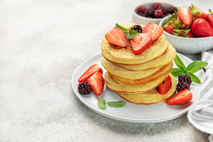 Stack of pancakes with strawberries and blackberries, a Food & Drink Photo by Olena Rudo