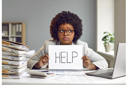 Tired woman sitting at desk at her