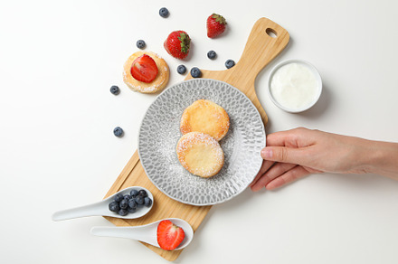 Concept of tasty sweet food, cheese pancakes, top view, a Food & Drink Photo by AtlasStudio PRO