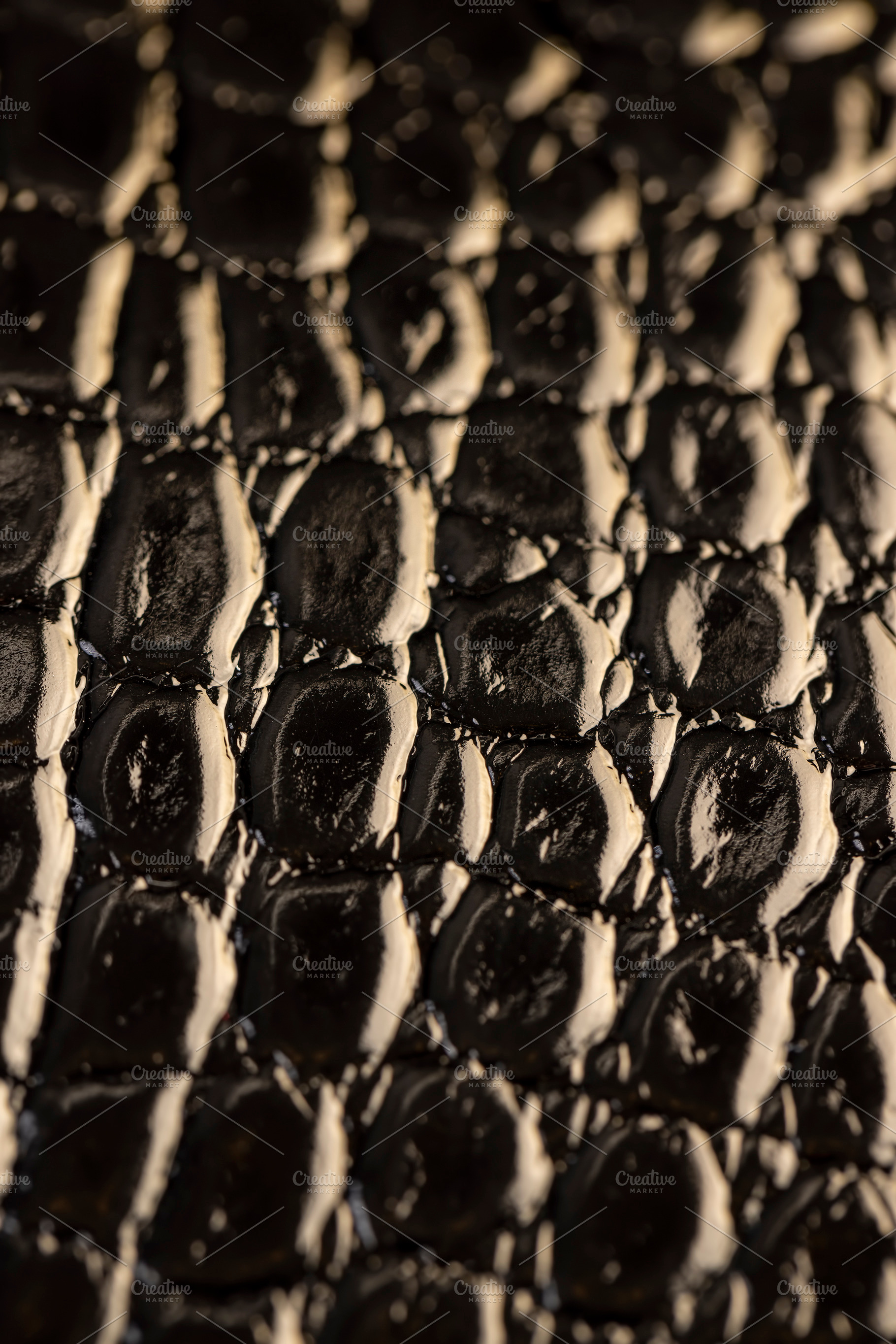 imitating crocodile leather for making objects, black polished leather dyed bla, a Photo by rsoollAI