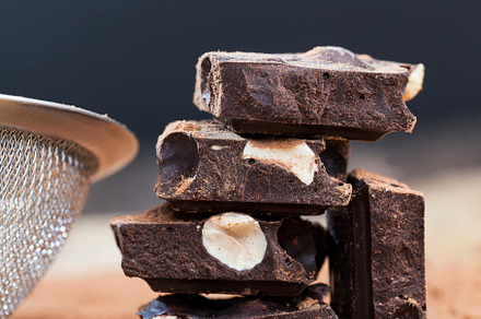 pieces of chocolate with hazelnuts, a Background Photo by MyPhotos