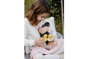Girl sitting on swing with baby, an Animal Photo by HalfPoint
