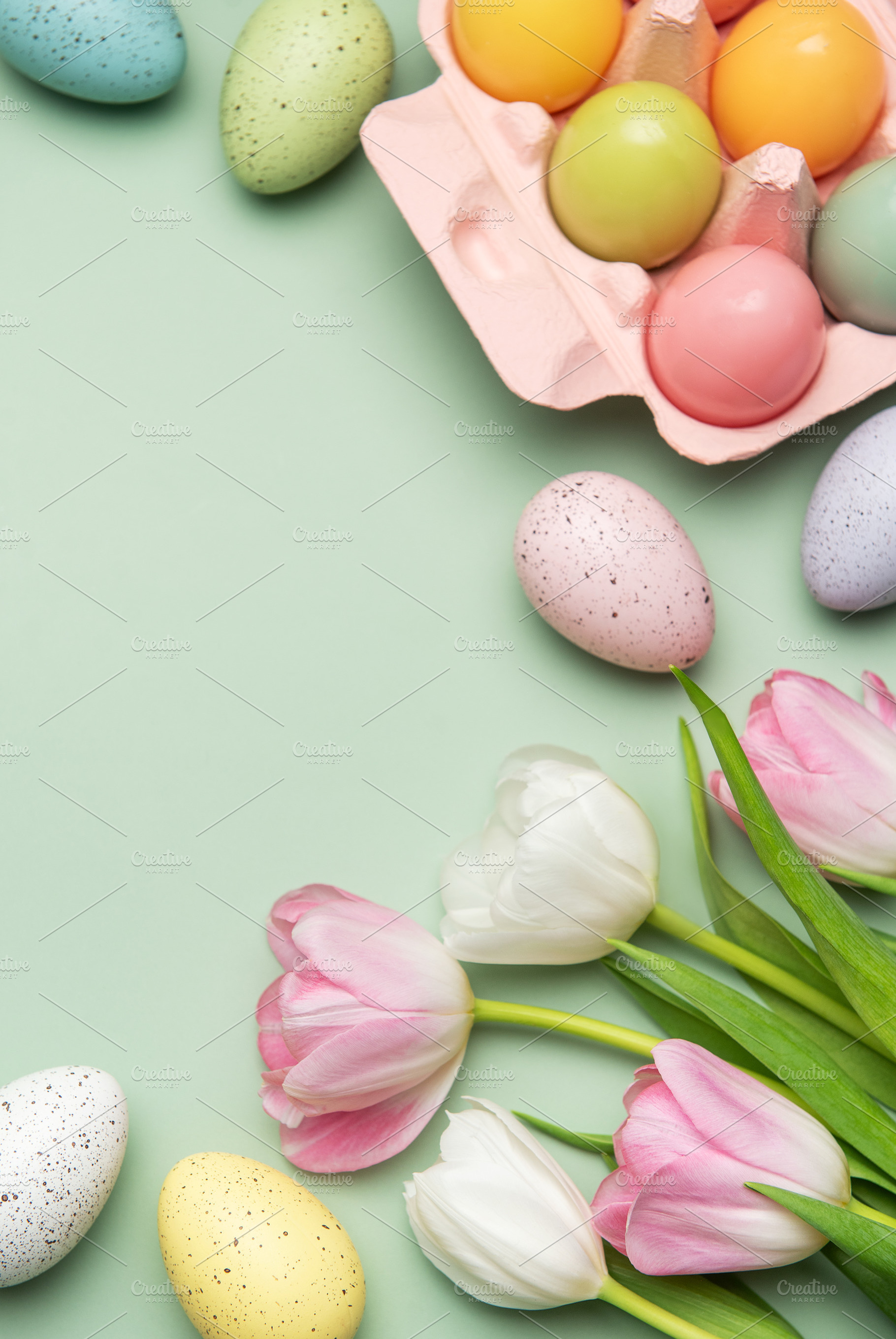Easter eggs and tulips creating a spring feeling on pastel green, a Holiday Photo by Olena Rudo