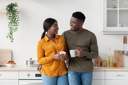 Romantic Young African American Couple Drinking Tea In Kitchen Together, a Photo by Prostock-Studio