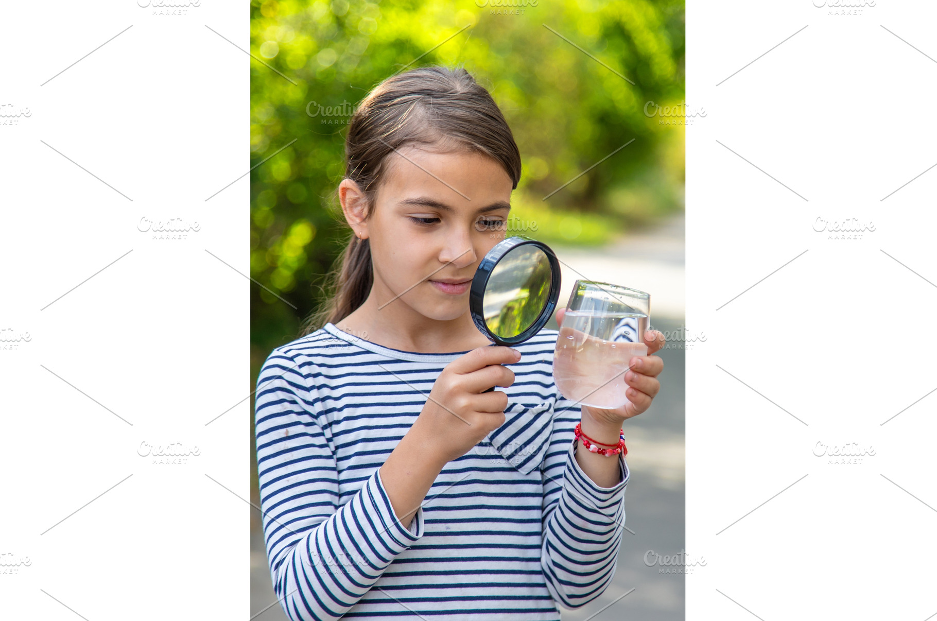 The child examines the water with a, a School & Education Photo by yanadjana