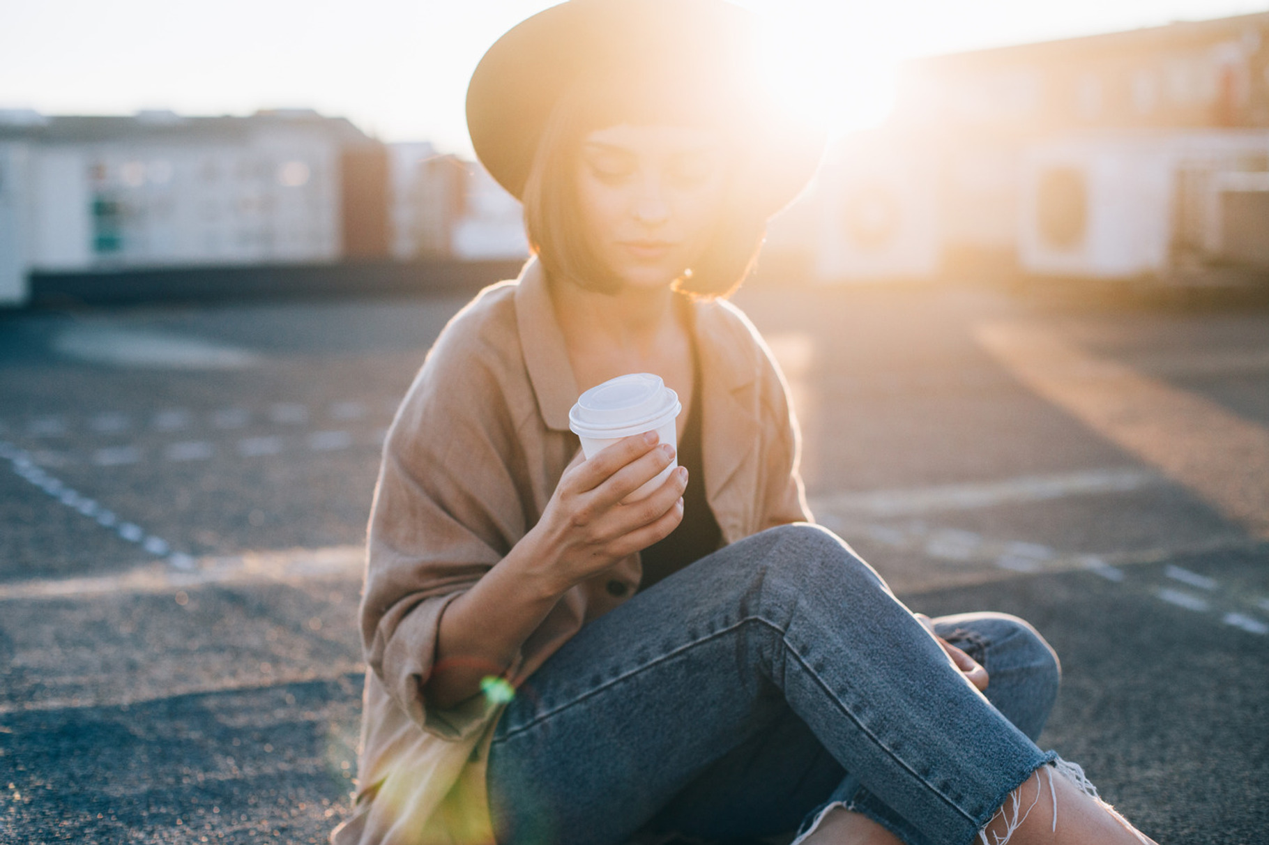 Cute girl sits on sunny rooftop containing woman, sun, and paper, a Beauty & Fashion Photo by DeRepente