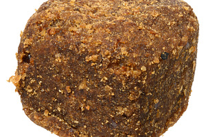 Brown dog snack or treat with a textured, crumbly surface, isola, a Food & Drink Photo by ndanko