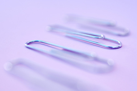 four paperclips on the purple background, a Photo by Peopleimages.com
