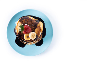 Pancakes with chocolate and fruit isolated on white background, a Food & Drink Photo by etorres69