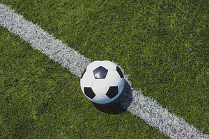 Soccer ball on green grass over the 