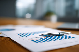 Charts and reports on a wooden table, a Photo by Beautiful things