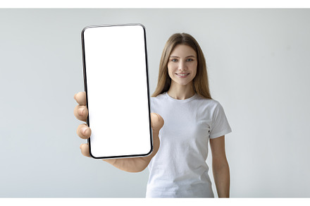 Lady holding mobile phone with empty, a Person Photo by Prostock-Studio