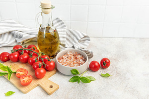 Fresh cherry tomatoes basil olive oil cooking ingredients, a Food & Drink Photo by Olena Rudo