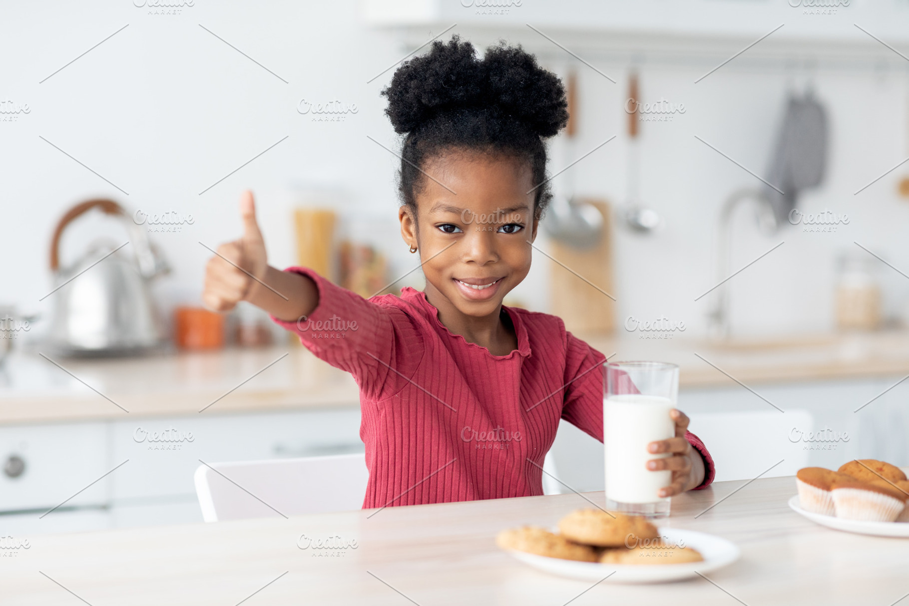 Happy african american kid drinking milk, showing thumb up, a Photo by Prostock-Studio