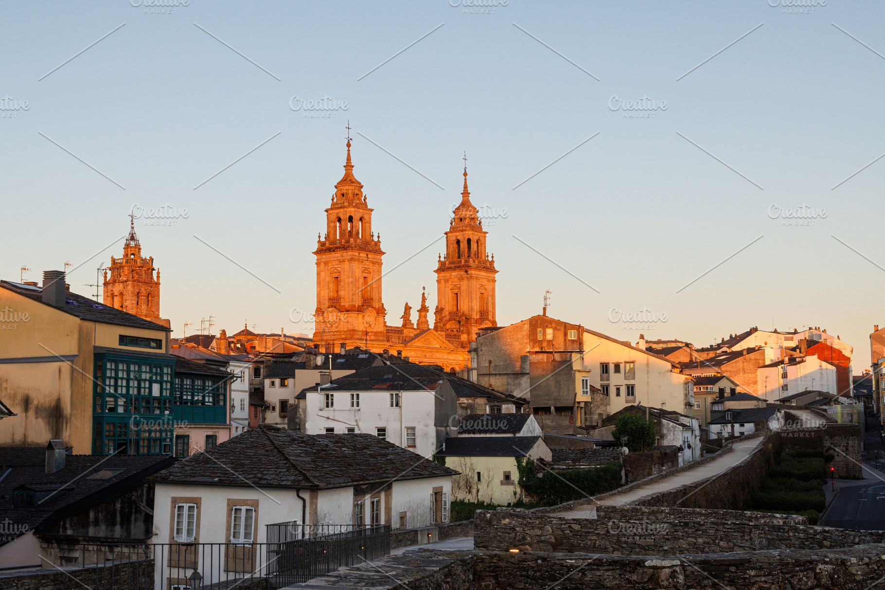 Cathedral bell towers at sunset viewed from the Roman walls in Lugo Spain, an Architecture Photo by Bepslabor