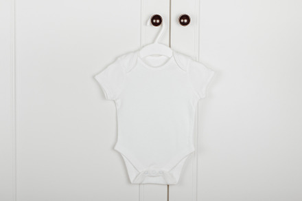Baby cute white bodysuit on a hanger, a Beauty & Fashion Photo by Kolomiyets Viktoriya