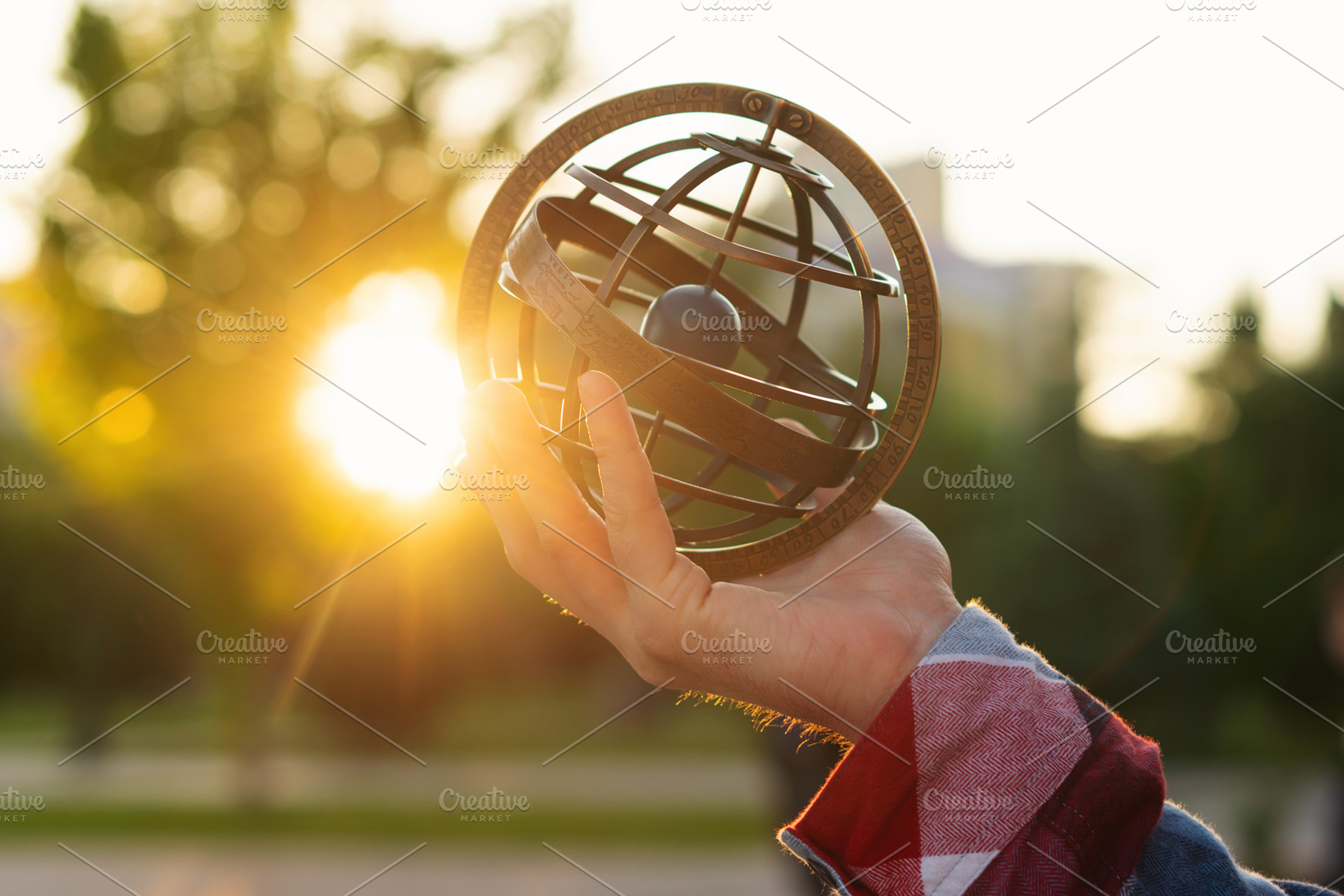Hand holding antique metal globe, a School & Education Photo by Elena Vagengeim