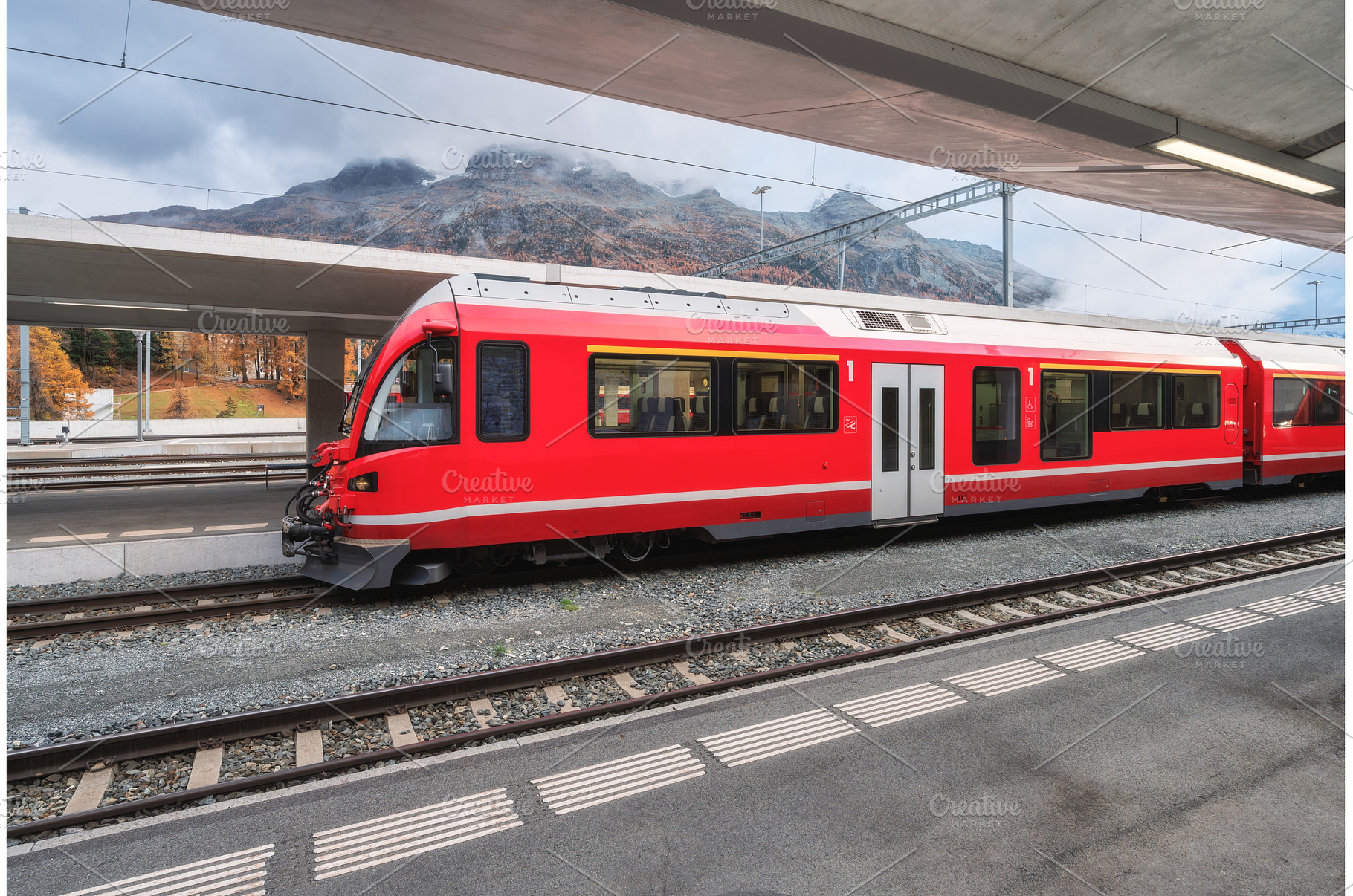 Red modern passenger train on, a Transportation Photo by den-belitsky