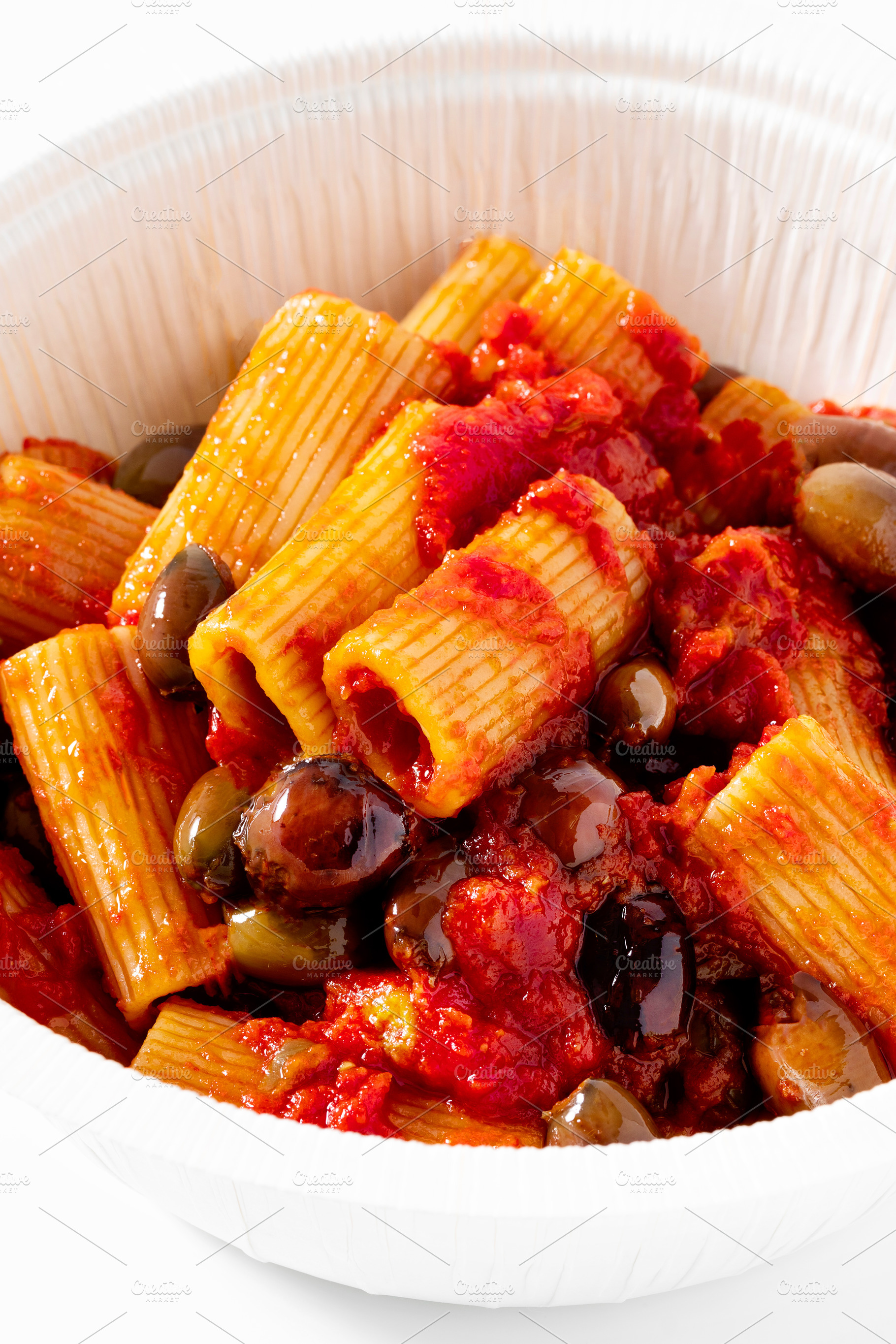 Italian tortiglioni pasta puttanesca with tomato sauce and black, a Food & Drink Photo by IriGri