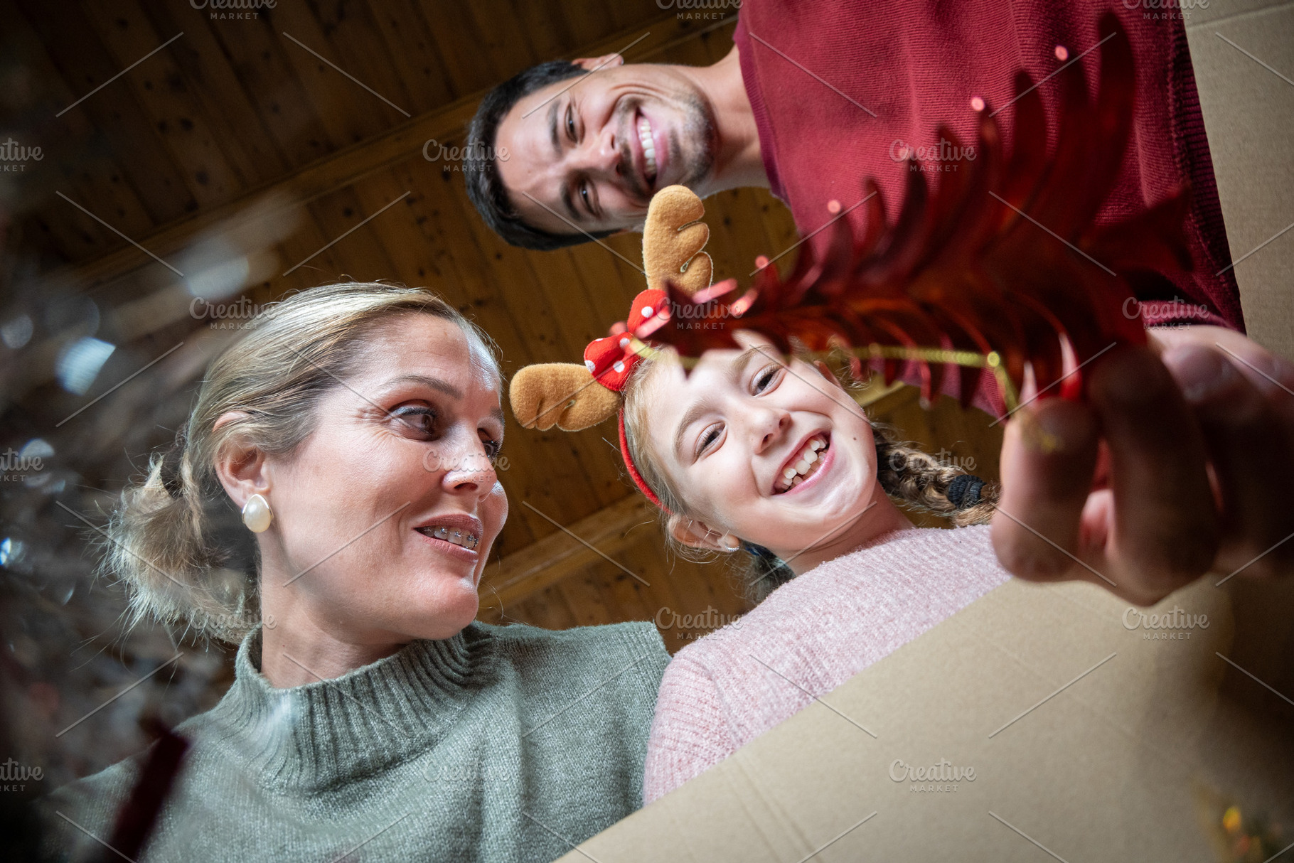 Smiling girl looking into box of Christmas decorations, a Holiday Photo by etorres69