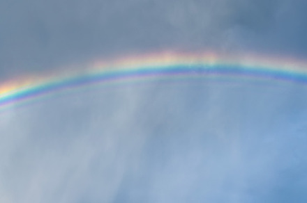 Blue sky and white cloud with sun light and rainbow, a Nature Photo by Byrdyak