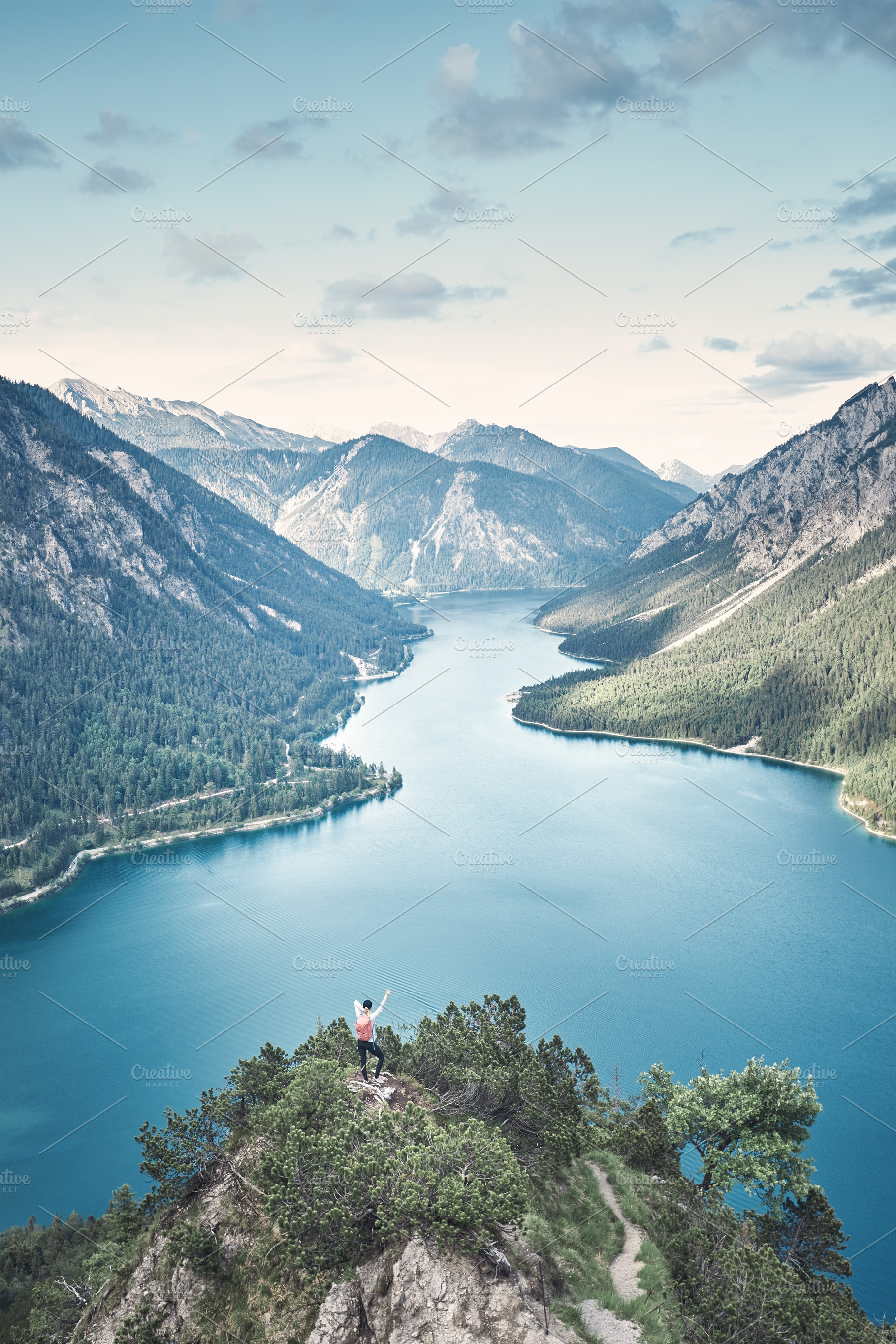 Woman on top of mountain near lake featuring achievement, active, and activity, a Nature Photo by Sergey Furtaev