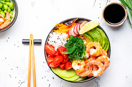 Poke bowl with shrimp, avocado, radish, carrot, tomato, seaweed, a Food & Drink Photo by 5PH