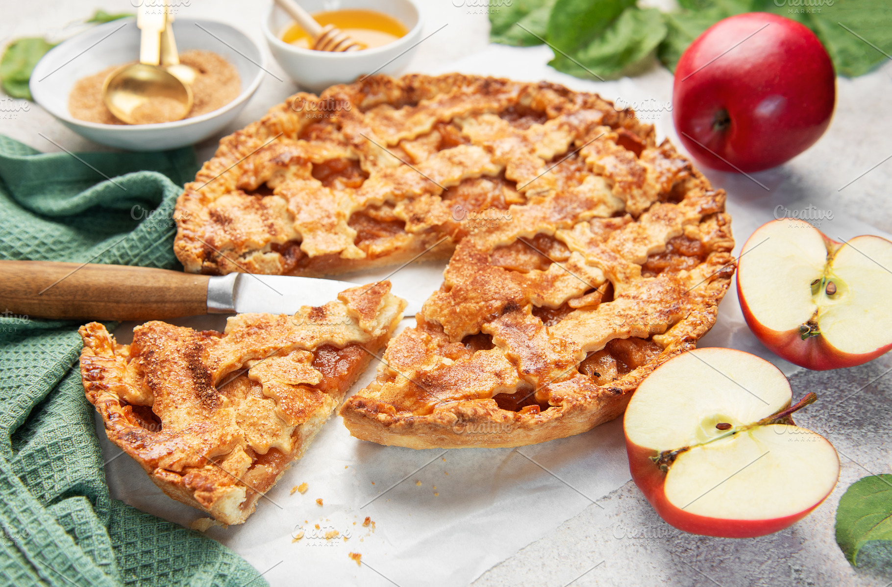Homemade apple pie with ingredients on concrete background, a Food & Drink Photo by Olena Rudo