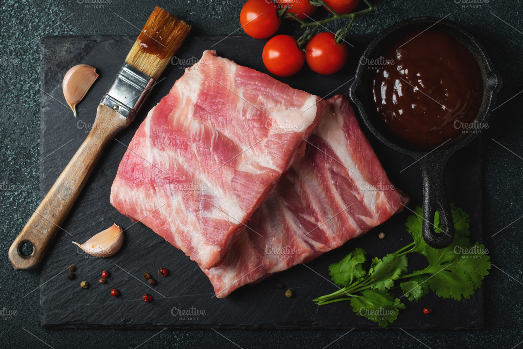 Raw meat. Raw pork ribs from the back with meat on a black background. backgrou, a Food & Drink Photo by Budarinphoto