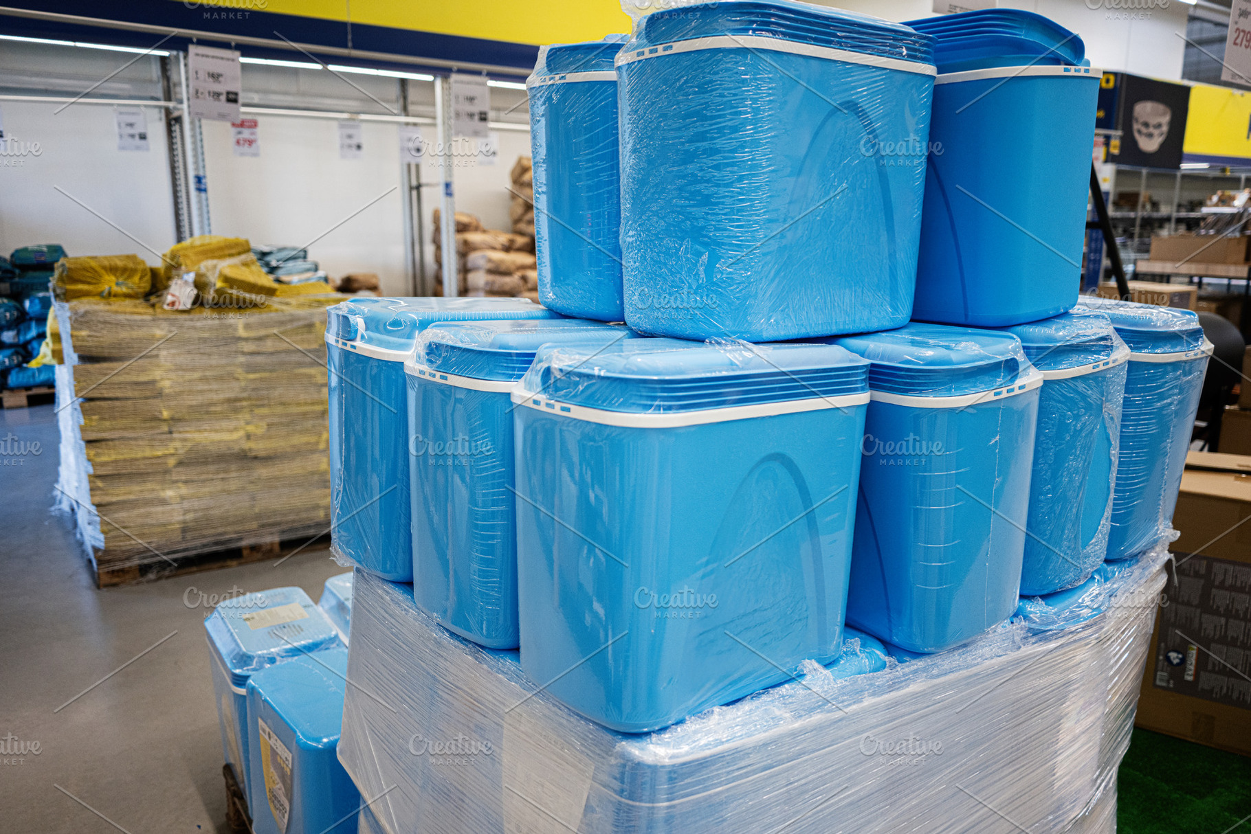 Blue storage containers displayed in a store aisle for retail purchase, a Photo by AS photostudio