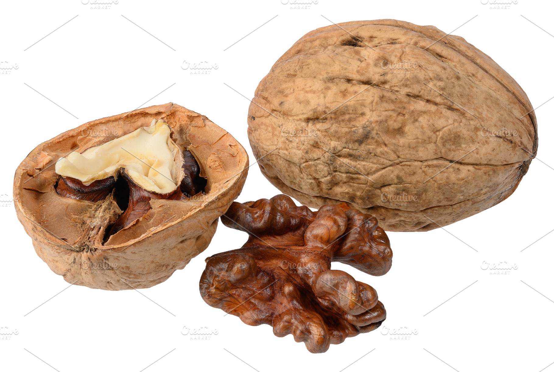A set of walnuts, including a whole walnut in its shell, a split, a Food & Drink Photo by ndanko