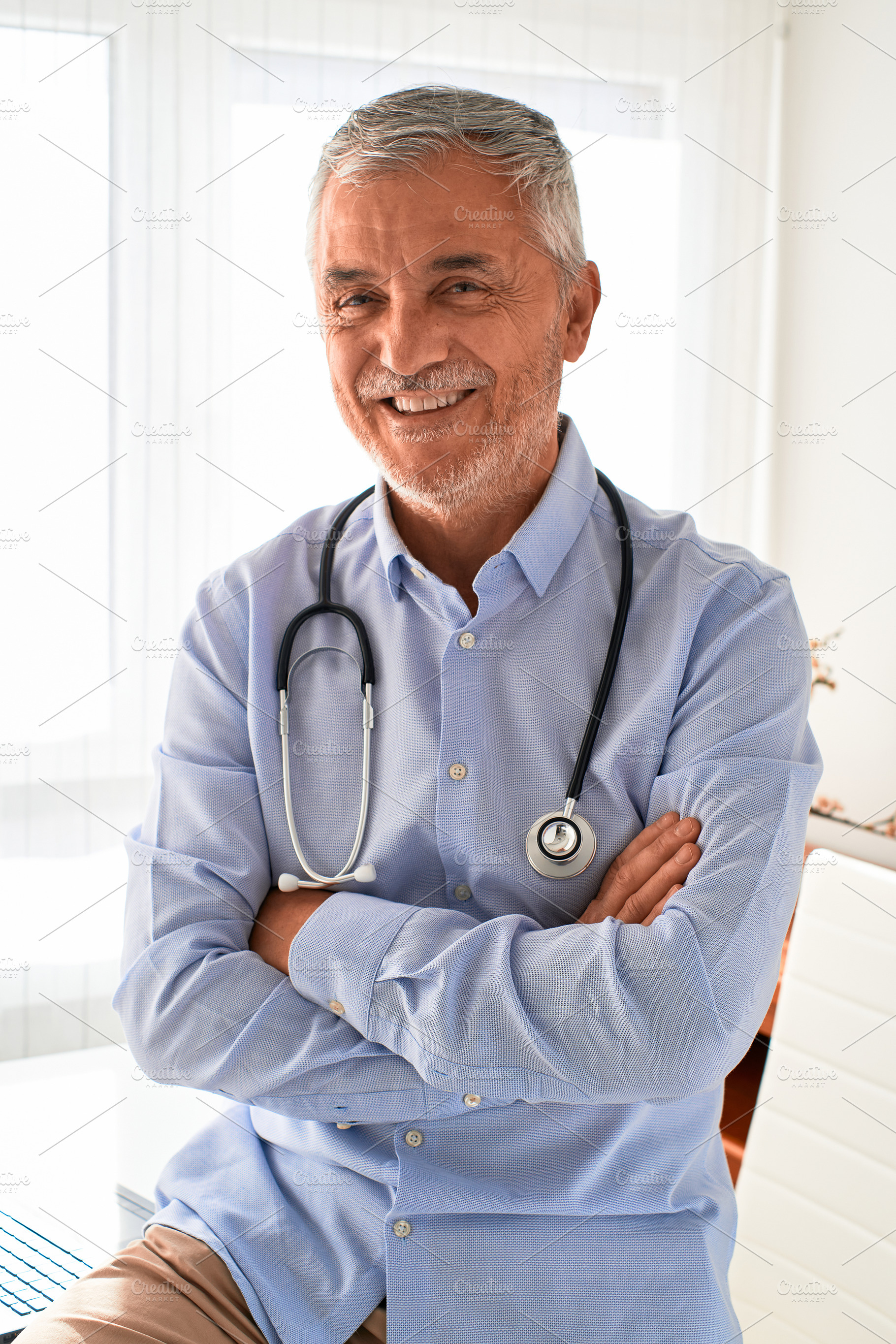 Portrait of mature doctor smiling an, a Person Photo by alfernec