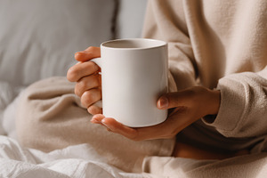 Woman holding cup on bed, a Person Photo by Virgo Studio