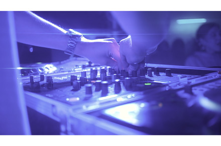 Woman works behind music mixer. Clip, a Person Photo by Media Whale Stock
