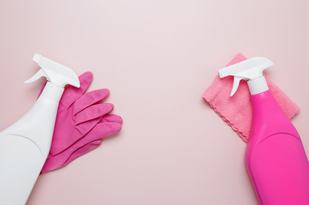 Pink cleaning supplies including rubber gloves, spray bottles, and microfiber c, a Photo by matucha