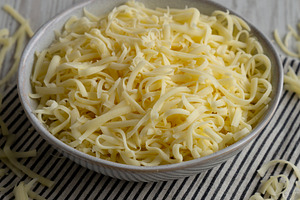 Organic Shredded Mozzarella Cheese in a Bowl, side view., a Food & Drink Photo by LiudmylaChuhunova