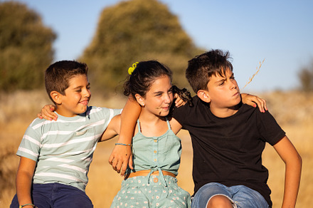 Three children enjoying their summer vacation in the countryside